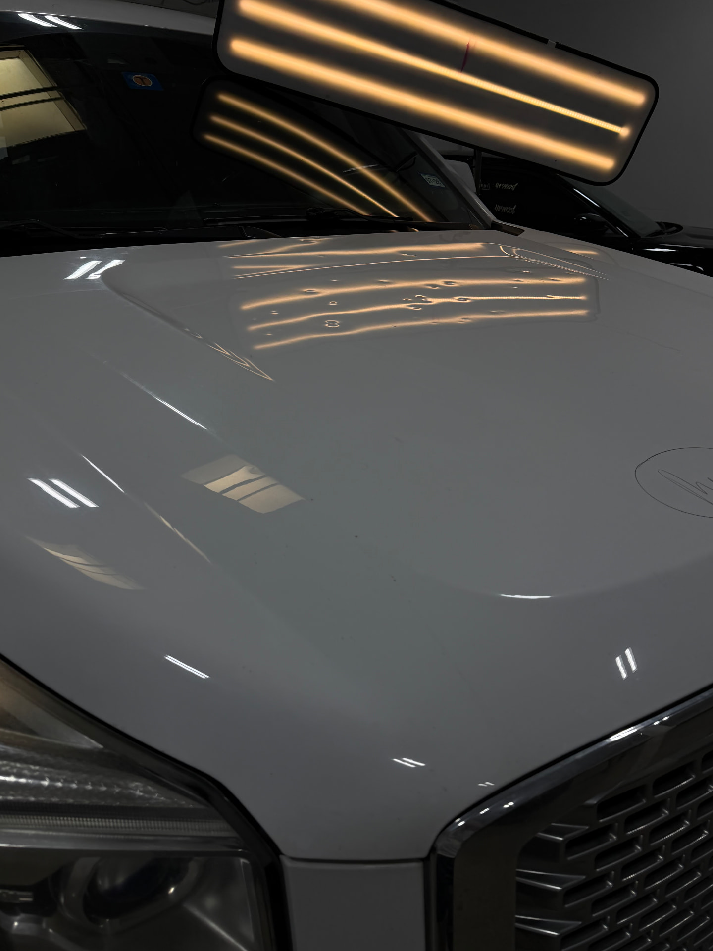 Pickup hood — moderate hail repaired with PDR — Before